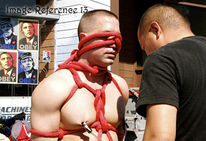 Man tied up in rope with nipple clamps on